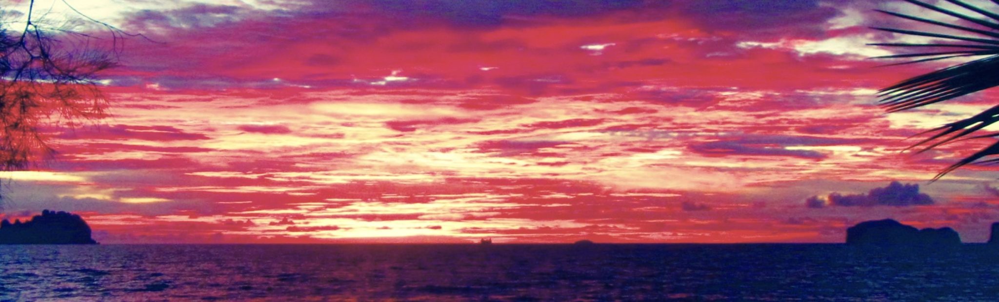 Crimson red sunset at Ko Sukon, Trang, Thailand | travel poem on urban nightlife 'Cracked Open' on the travel blog Teja on the Horizon