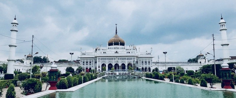Travel guide 'One Day in Lucknow: The Imambaras, the Bowli, and the Labyrinth' on travel blog Teja on the Horizon | The imposing gold domed white building of Chota Imambara in Lucknow, India, across its reflecting pool | A 1-day itinerary for what to do in Lucknow, Uttar Pradesh