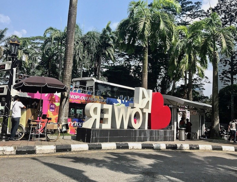 Hop On Hop Off bus at KL Tower beyond the I [heart] KL Tower sign 