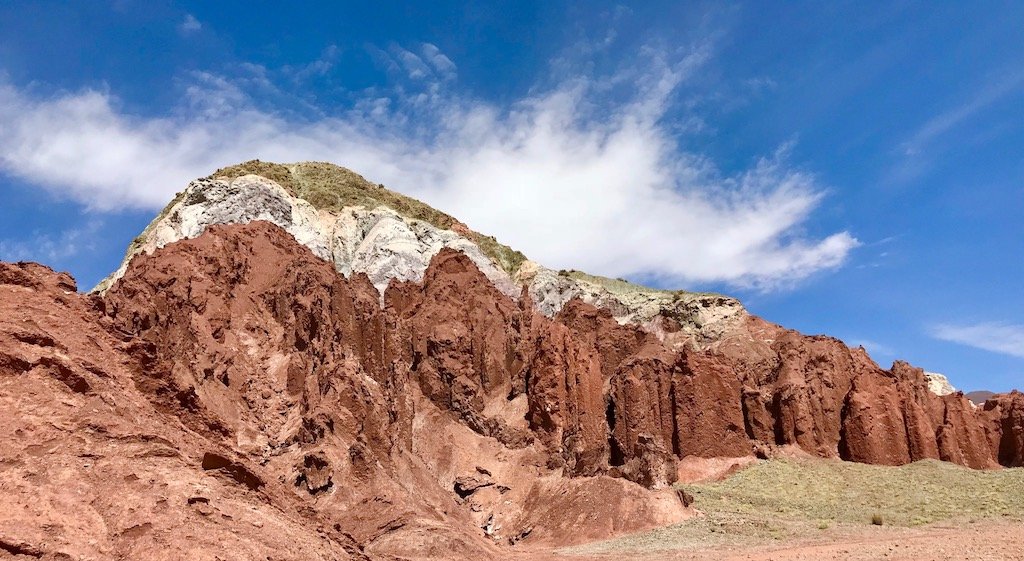 'Half-Day Tour of Atacama's Rainbow Valley: What to Expect' travel guide on sustainable travel blog Teja on the Horizon | green-white-red rock layers in Valle del Arcoiris in the Atacama desert
