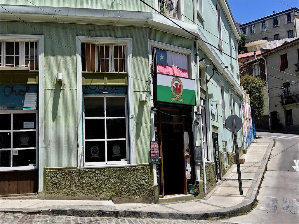 Valparaiso's Unexpected British Chilean Heritage | article on slow travel blog Teja on the Horizon | Chilean flag over Welsh flag over the entrance of Brecons restaurant in Valparaiso