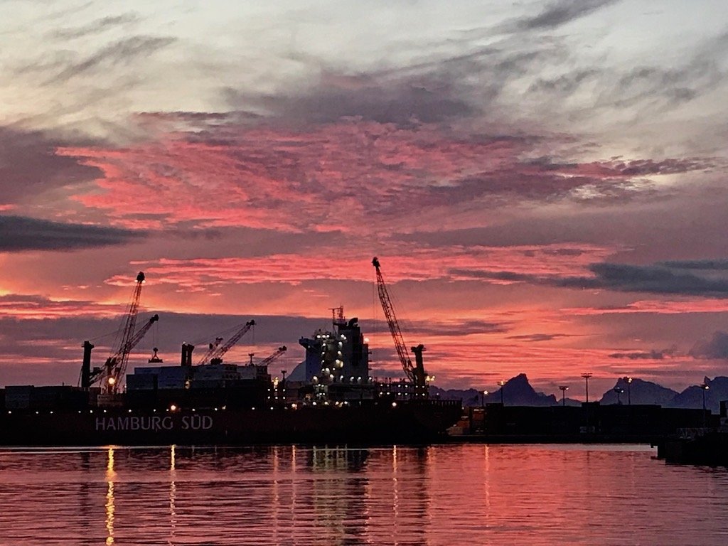 Coral pink sunset behind a cargo ship in Papeete harbour, Tahiti | 4 Reasons to Have a Long Layover in Pape'ete