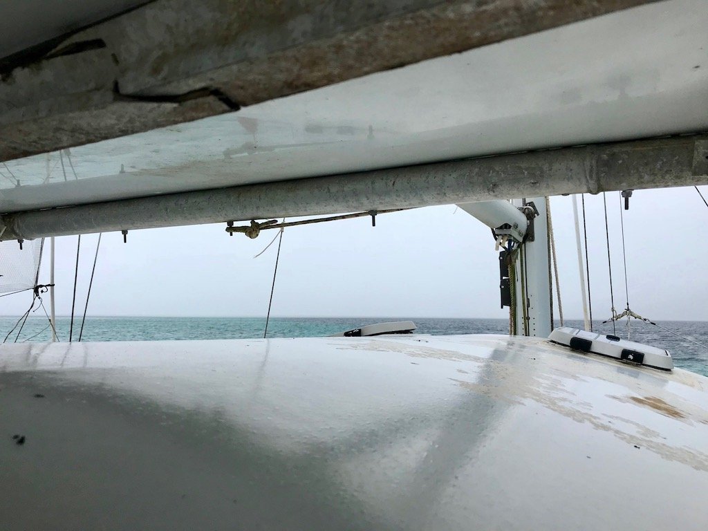 View of incoming rain from between cabin roof and tarp overhead