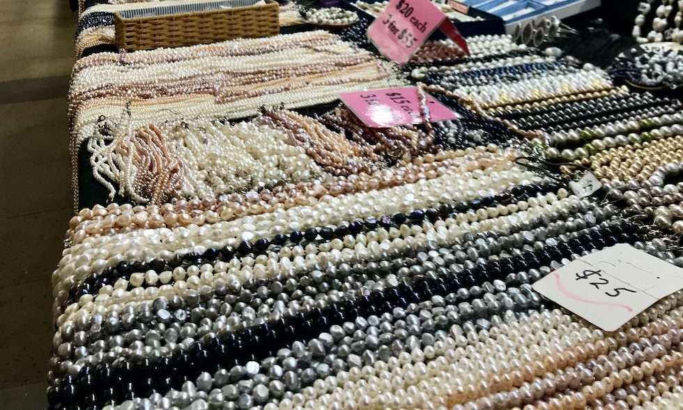 Strings of Pacific South Sea pearls on a table in the Cairns market