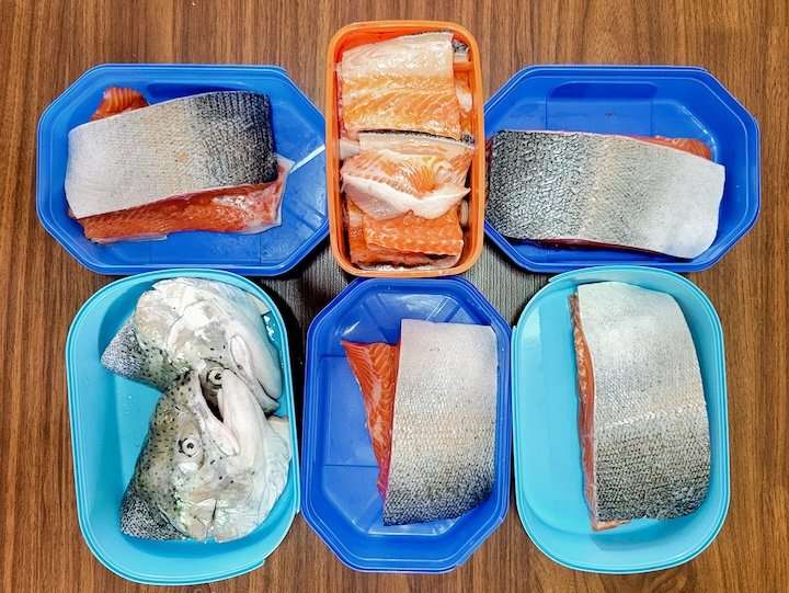 Zero waste grocery shopping by using old ice cream containers to buy fish